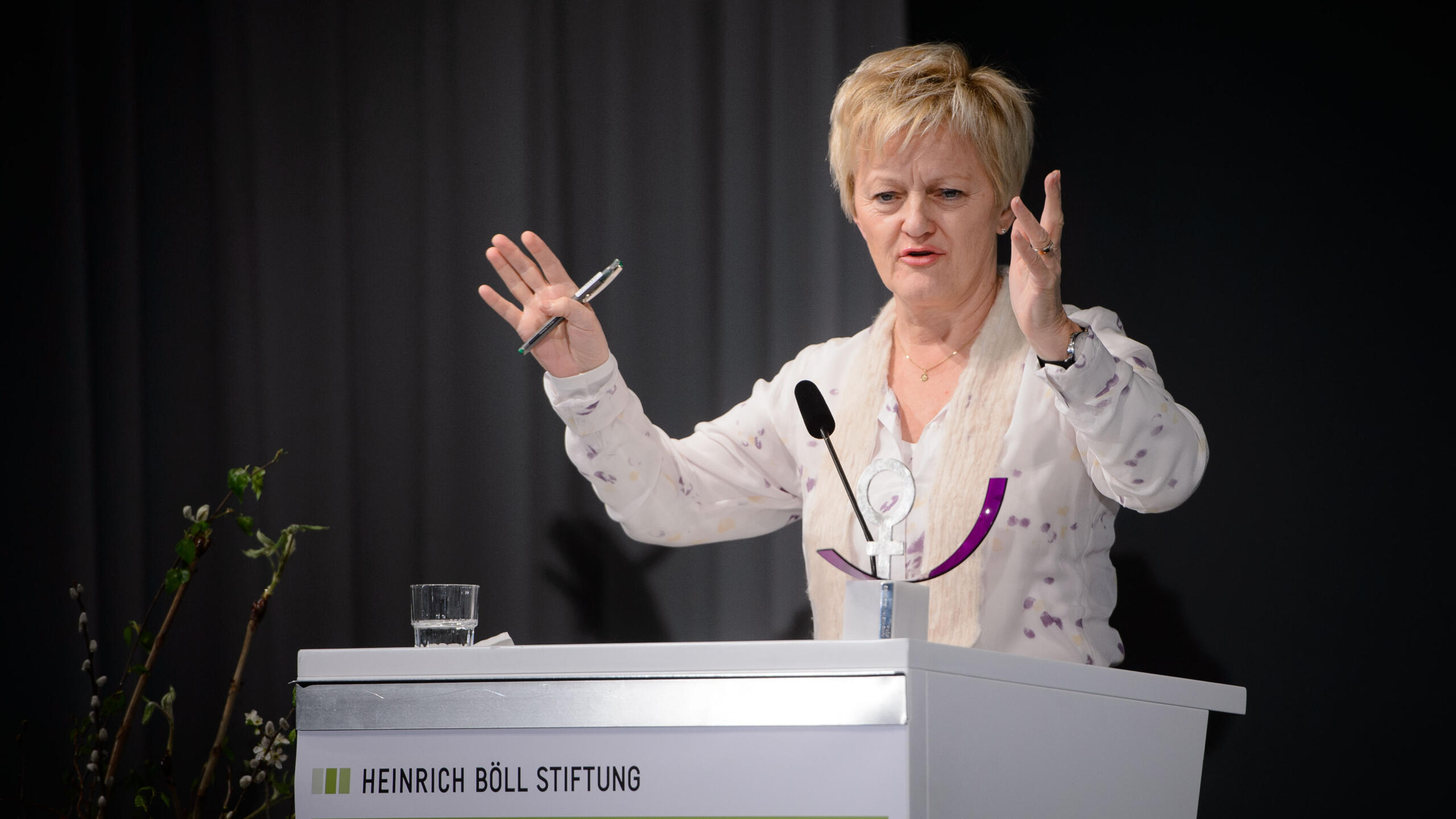 Renate Künast steht vor einem Podest