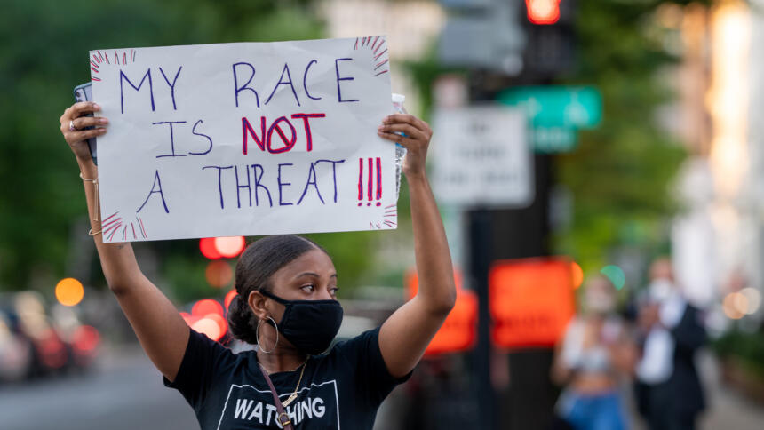 Eine Demonstrantin protestiert gegen Polizeigewalt und systemischen Rassismus.