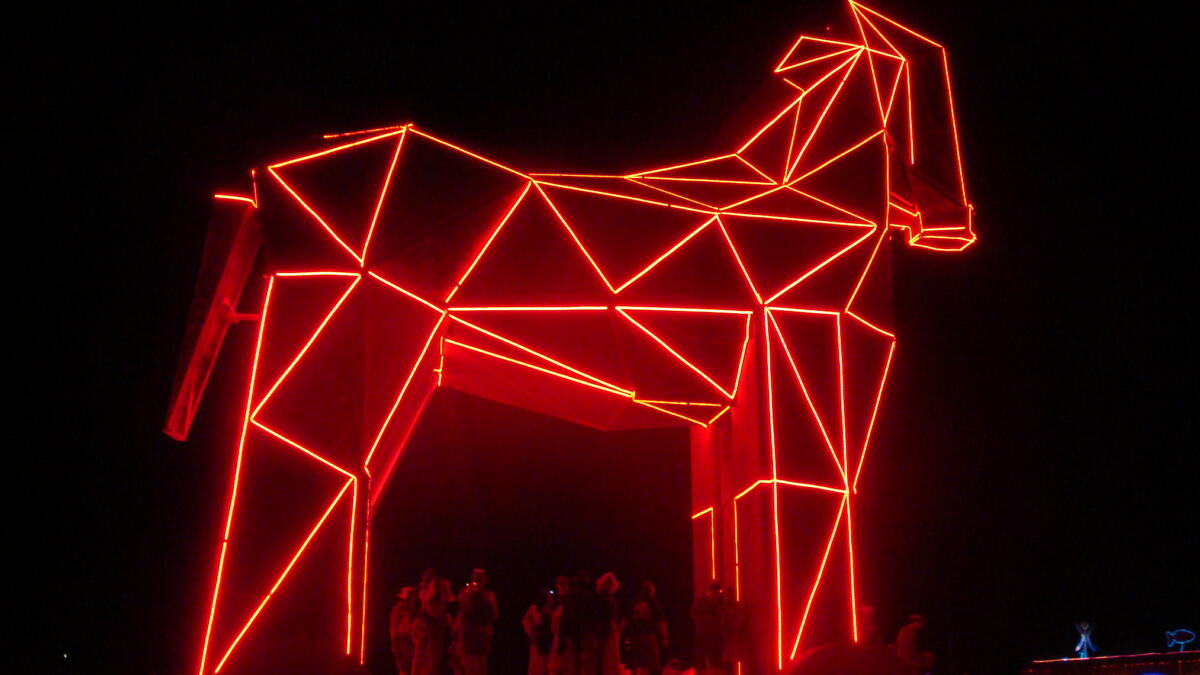 Ei aus Dreiecken zusammengesetzte, rot beleuchtete Pferdefigur