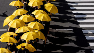 Demonstration von oben, zu sehen sind vor allem gelbe Regenschirme