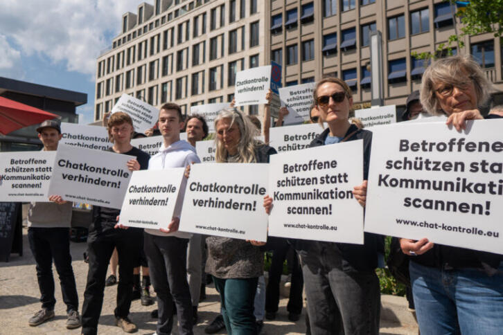 Die Demonstration vor dem Gebäude der Vertretung der EU-Kommssion in Berlin. Einige Demonstrierende tragen Schilder. Auf den Schildern steht "Chatkontrolle verhindern!" oder "Betroffene schützen statt Kommunikation scannen!"