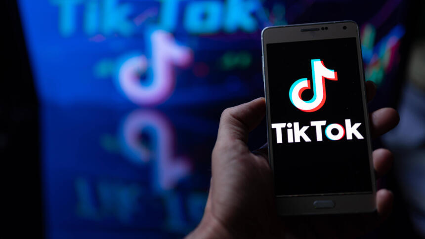Handy mit TikTok-Logo in einer Hand