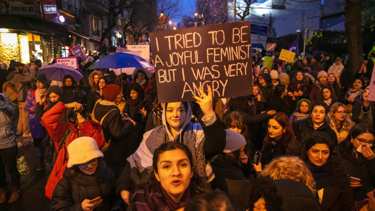 Demonstration, in der Mitte ein Schild mit der Aufschrift: Ich habe versucht, eine fröhliche Feministin zu sein, aber ich war sehr wütend.