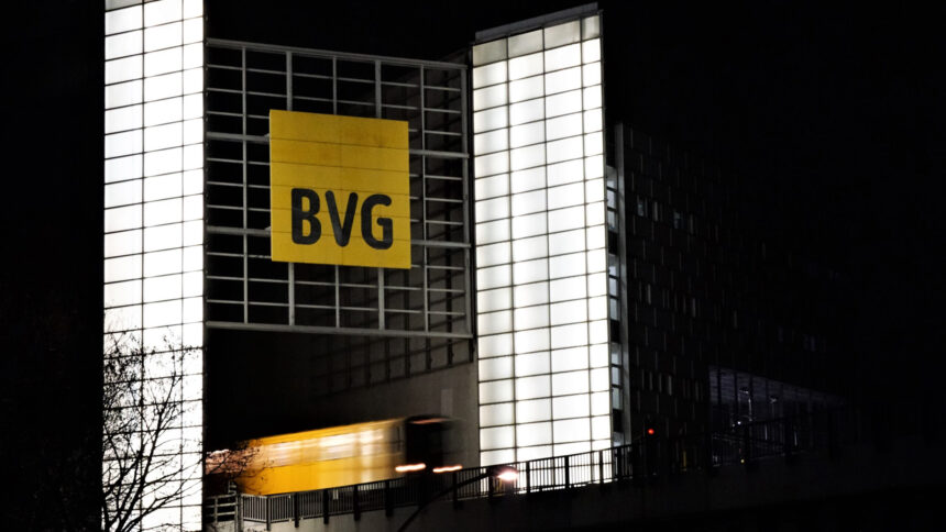 Auf einem Hochhaus ist das BVG-Logo,unten fährt eine U-Bahn