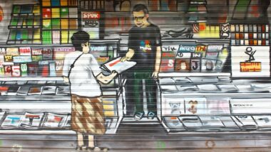 Grafitti auf einem Rolladen: Mann mit Brille gibt Frau eine Zeitung.