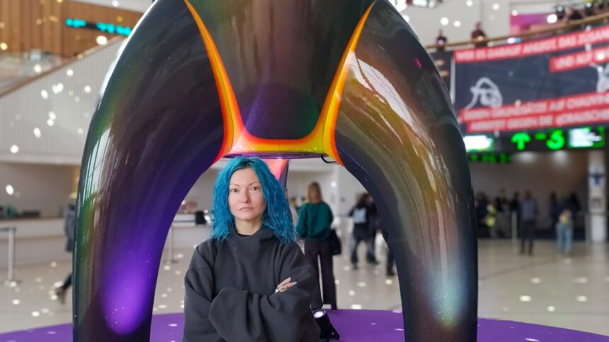 Helena Nikonole stands in front of the ‘Fairy Dust’ rocket, the mascot of the Chaos Computer Club, in the foyer of the Congress Centre Hamburg.