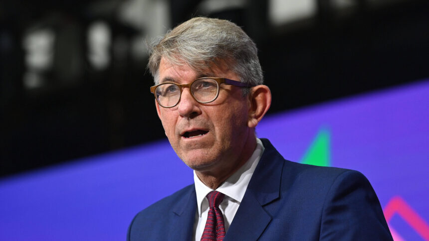 Mann mit Anzug und Brille und geöffnetem Mund