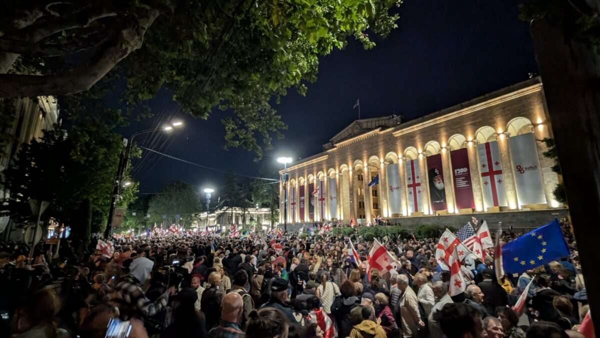 Demonstrierende bei Nacht vor einem Gebäude
