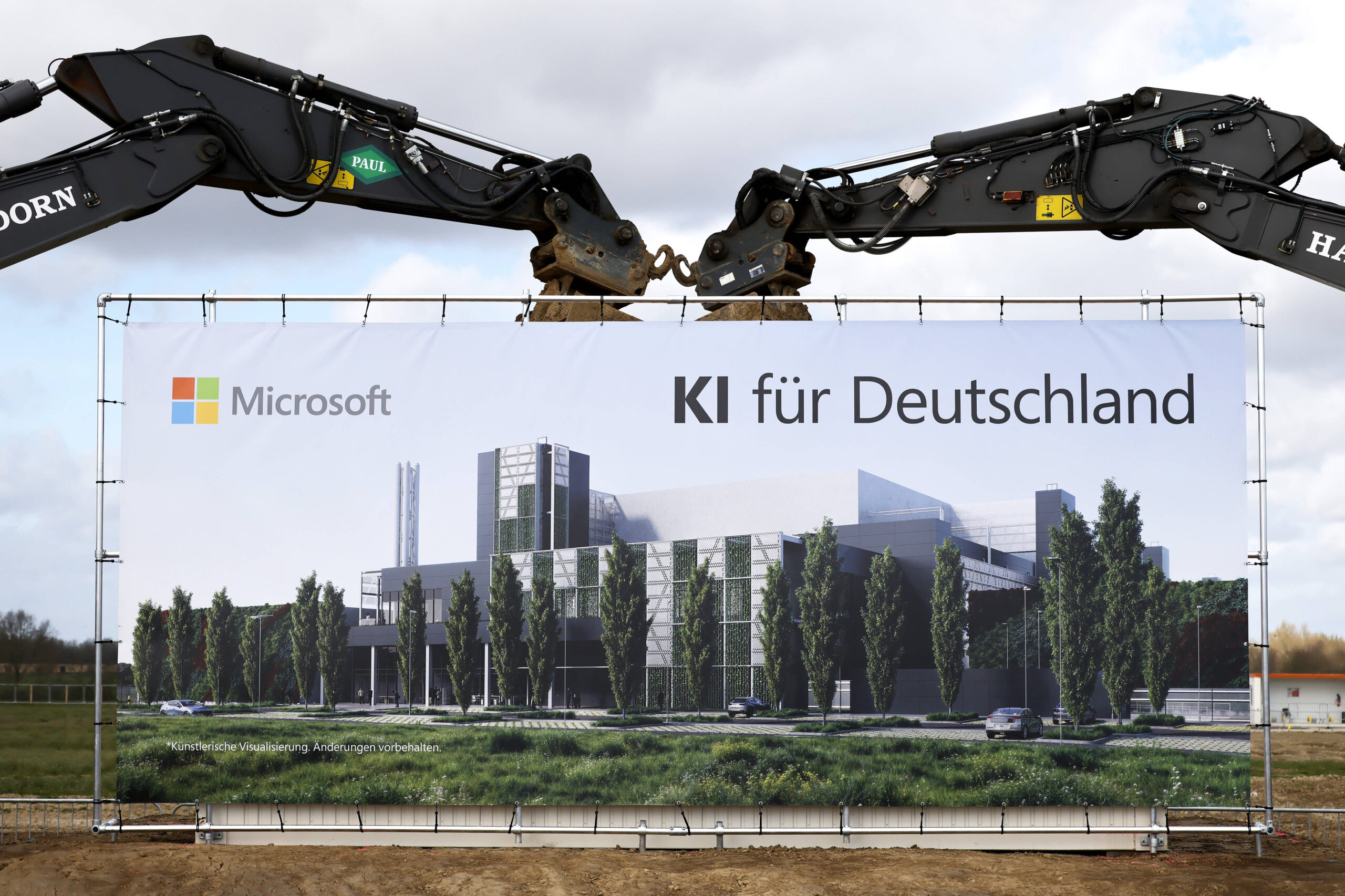 Ein Plakat mit Werbung für einen Rechenzentrumsneubau von Microsoft, Schriftzug: "KI für Deutschland", im Hintergrund zwei Baggerarme